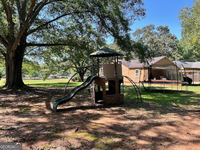 view of jungle gym with a trampoline and a yard