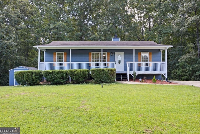 view of front of property with a porch, a chimney, and a front yard