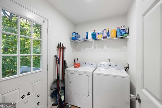 clothes washing area with washing machine and clothes dryer and a healthy amount of sunlight