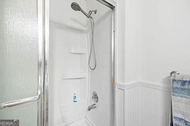 bathroom with a shower with shower door