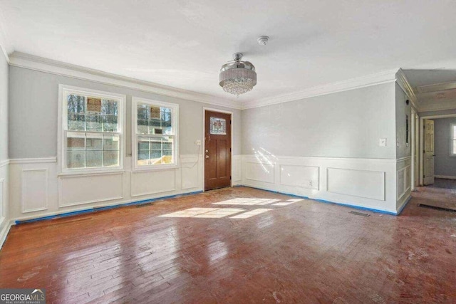 entrance foyer featuring hardwood / wood-style floors and ornamental molding