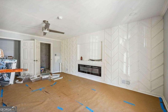 interior space featuring ceiling fan and crown molding