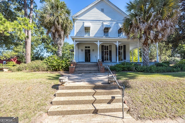 view of front of property featuring covered porch and a front yard