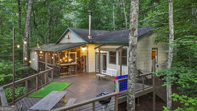 rear view of property with a wooden deck