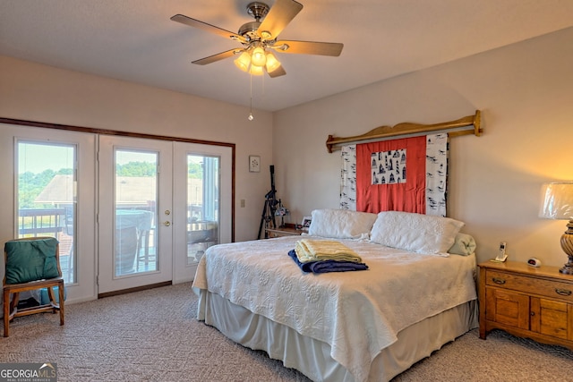 carpeted bedroom with french doors, ceiling fan, multiple windows, and access to exterior