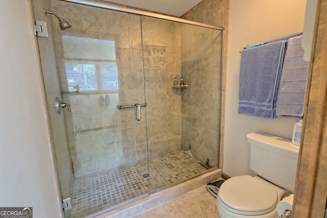 bathroom with toilet, walk in shower, and tile patterned flooring