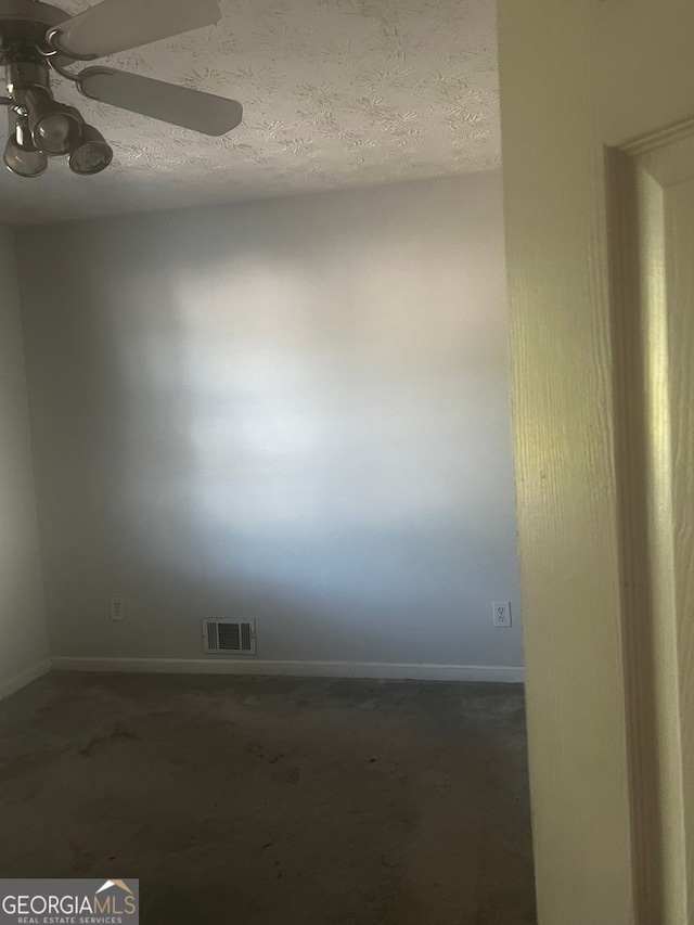 spare room featuring ceiling fan and a textured ceiling