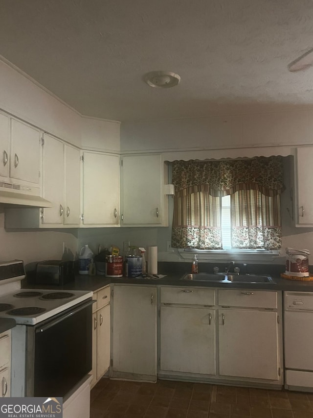 kitchen with a textured ceiling, white cabinetry, sink, and white appliances