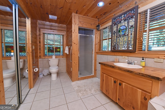 bathroom with vanity, tile patterned flooring, toilet, and an enclosed shower