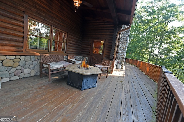 wooden deck with a fire pit