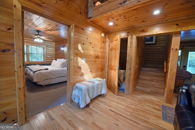 bedroom with ceiling fan, wood ceiling, and light hardwood / wood-style floors