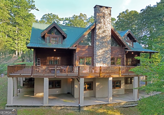 rear view of house with a deck and a patio area