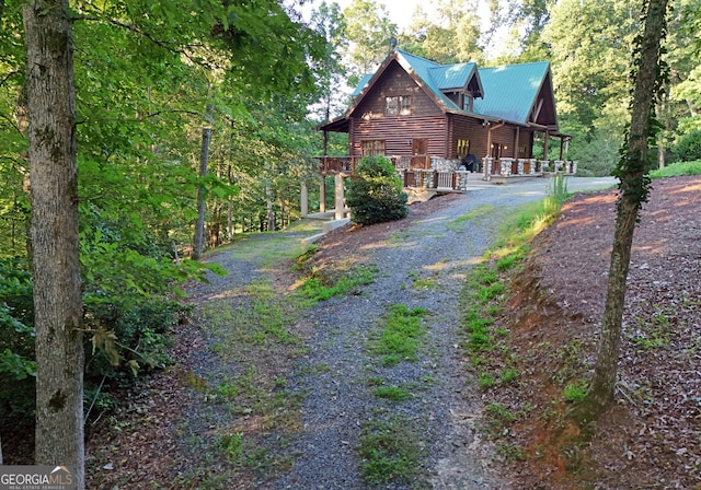 view of side of home with covered porch