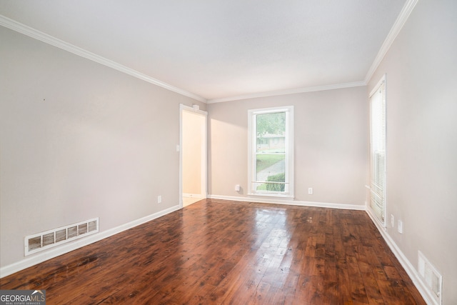 spare room featuring crown molding and dark hardwood / wood-style flooring