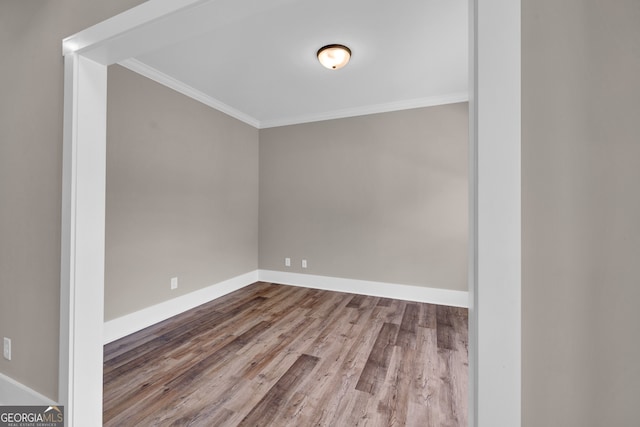 spare room featuring ornamental molding and hardwood / wood-style flooring