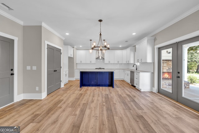 kitchen with pendant lighting, a notable chandelier, white cabinetry, light hardwood / wood-style flooring, and dishwasher