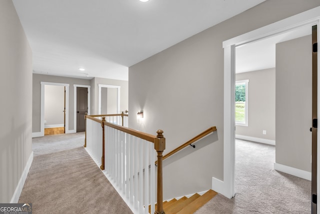 hallway featuring light carpet