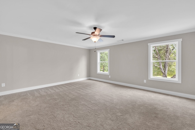 carpeted empty room featuring crown molding and ceiling fan