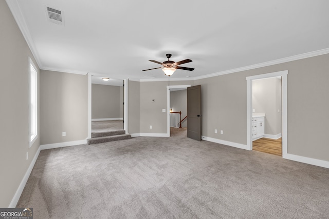 unfurnished bedroom featuring crown molding, ceiling fan, carpet, and ensuite bathroom