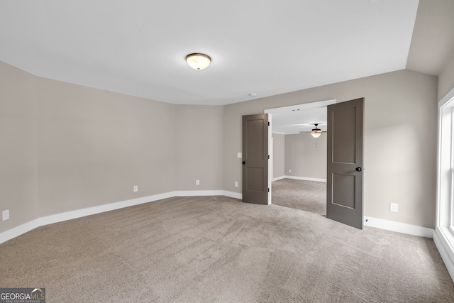 unfurnished bedroom with light colored carpet and vaulted ceiling