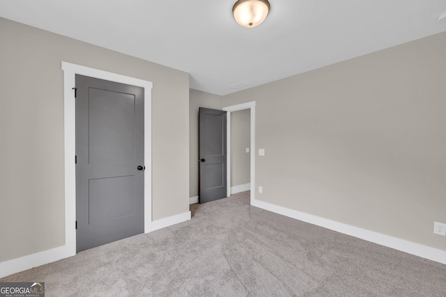 unfurnished bedroom featuring light carpet