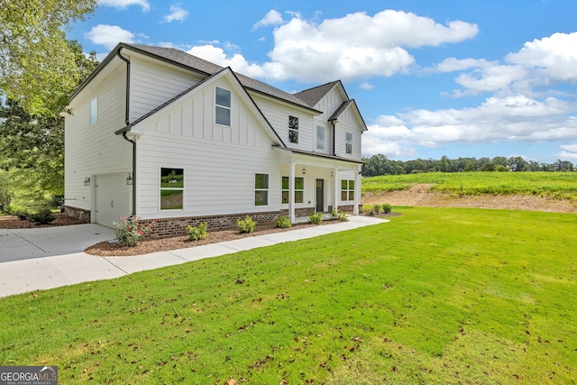 view of front of property with a front yard and a garage