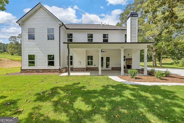 rear view of house with a patio area, a yard, and ceiling fan