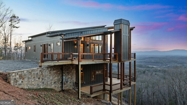 back house at dusk featuring a mountain view