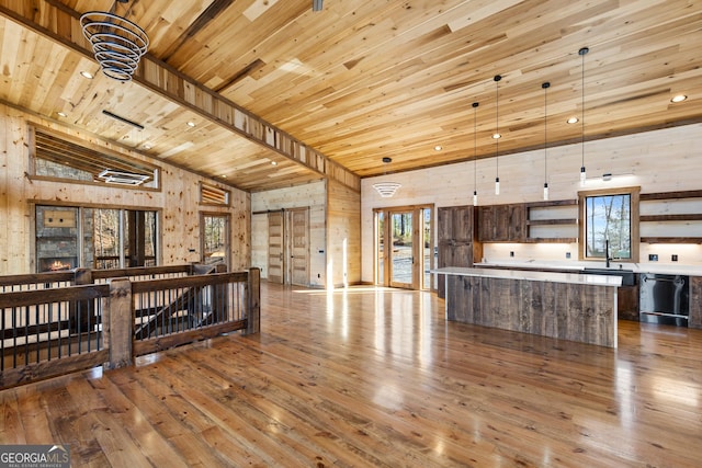 kitchen featuring a kitchen island, pendant lighting, black dishwasher, wood ceiling, and light hardwood / wood-style flooring