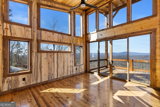 sunroom with a mountain view and wooden ceiling