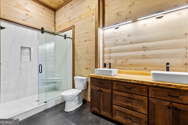 bathroom with vanity, wooden walls, a shower with door, and toilet