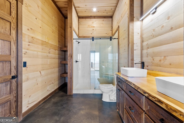 bathroom featuring a shower with door, vanity, concrete floors, toilet, and wood walls