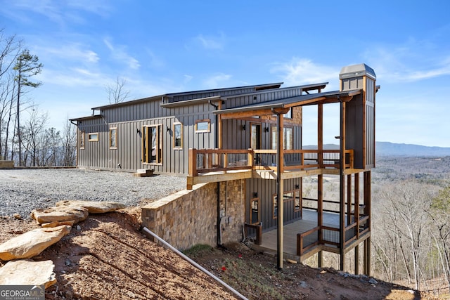 rear view of property featuring a mountain view