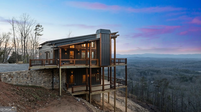 back house at dusk featuring a mountain view