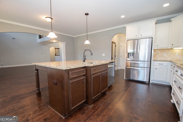 kitchen with dark hardwood / wood-style flooring, stainless steel appliances, sink, a center island with sink, and white cabinets