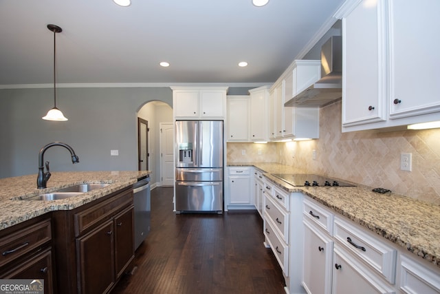 kitchen featuring sink, white cabinets, wall chimney range hood, and appliances with stainless steel finishes