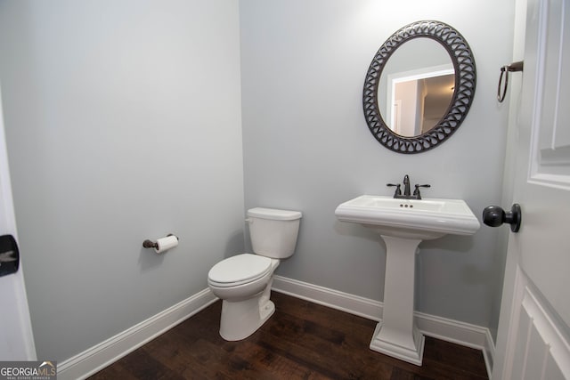 bathroom featuring sink, hardwood / wood-style floors, and toilet