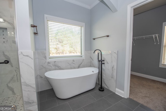 bathroom with tile patterned flooring, shower with separate bathtub, crown molding, and tile walls