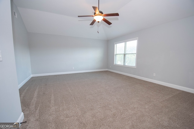 empty room with carpet, ceiling fan, and vaulted ceiling