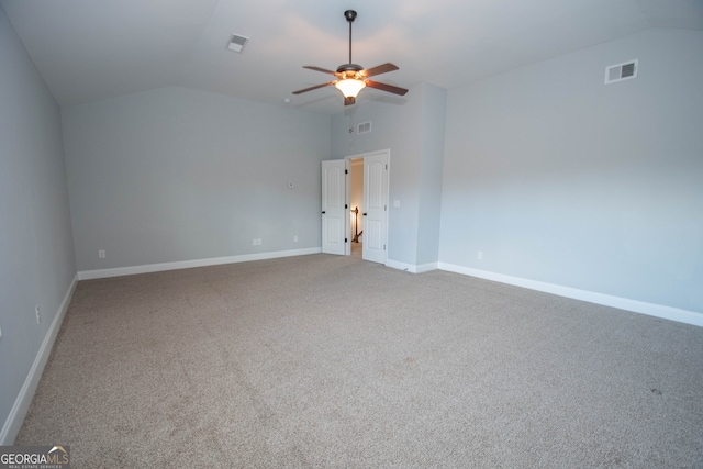 carpeted spare room with ceiling fan and lofted ceiling