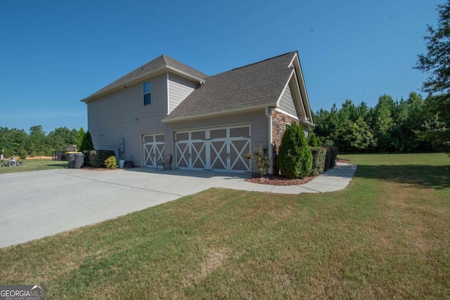 view of side of home with a lawn