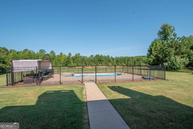 exterior space featuring a fenced in pool, a patio area, and a lawn