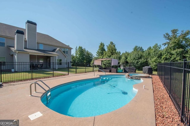 view of pool featuring a lawn, an in ground hot tub, and a patio