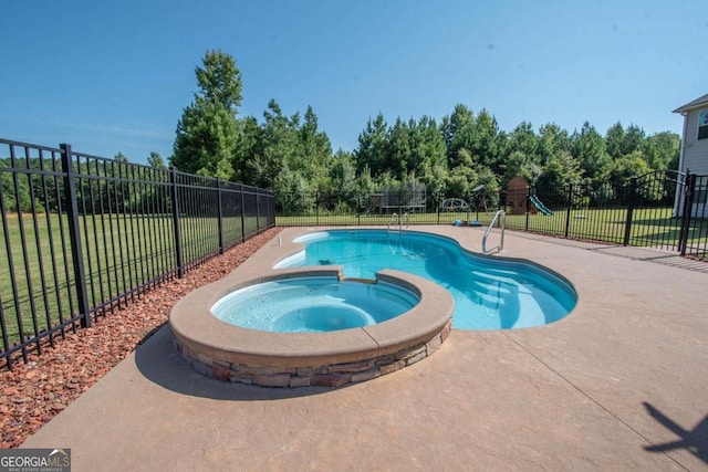 view of pool featuring an in ground hot tub, a yard, and a patio area