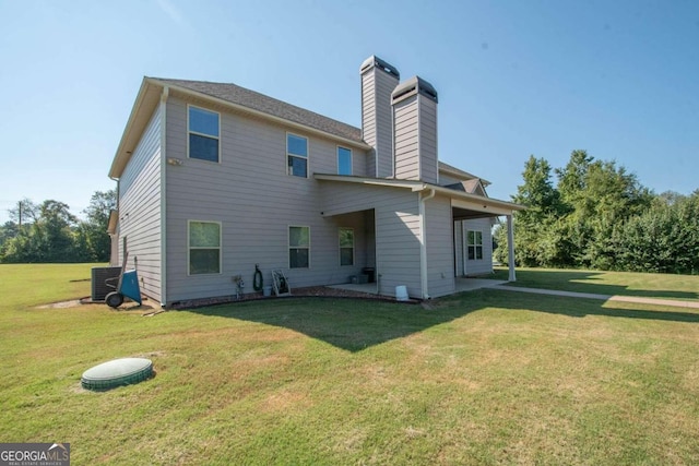 rear view of house featuring a lawn