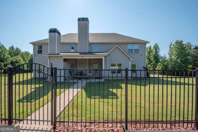 rear view of house with a yard