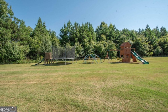 view of yard featuring a playground and a trampoline