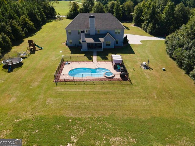 view of pool with a playground and a yard