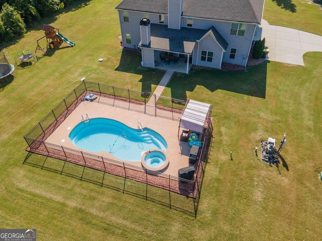 view of pool with a patio area, a playground, and a yard