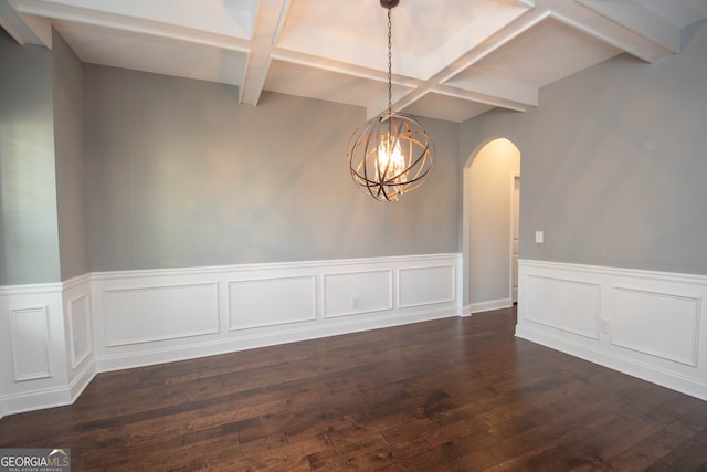 spare room featuring beam ceiling, an inviting chandelier, dark wood-type flooring, and coffered ceiling